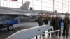 A group of Polish Air Force pilots stand next to a F-16 fighter jet and a model of a JASSM missile as they attend a contract signing ceremony of 40 Lockheed Martin’s joint air-to-surface standoff missiles (JASSM), as well as F-16 fighter plane…